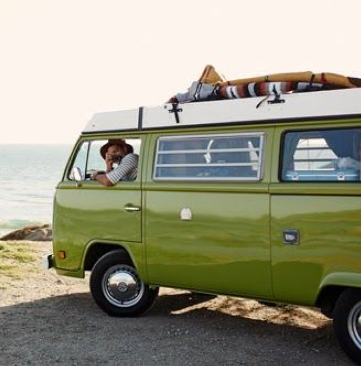 old green van with driver taking photo